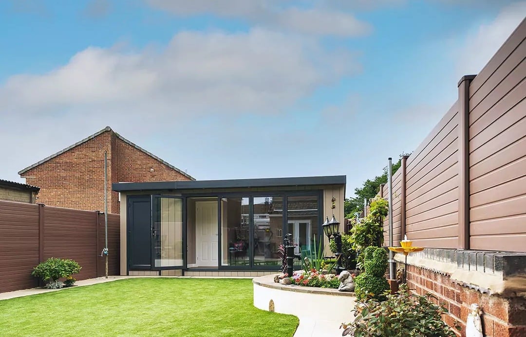 A garden building set into the back end of an English garden.