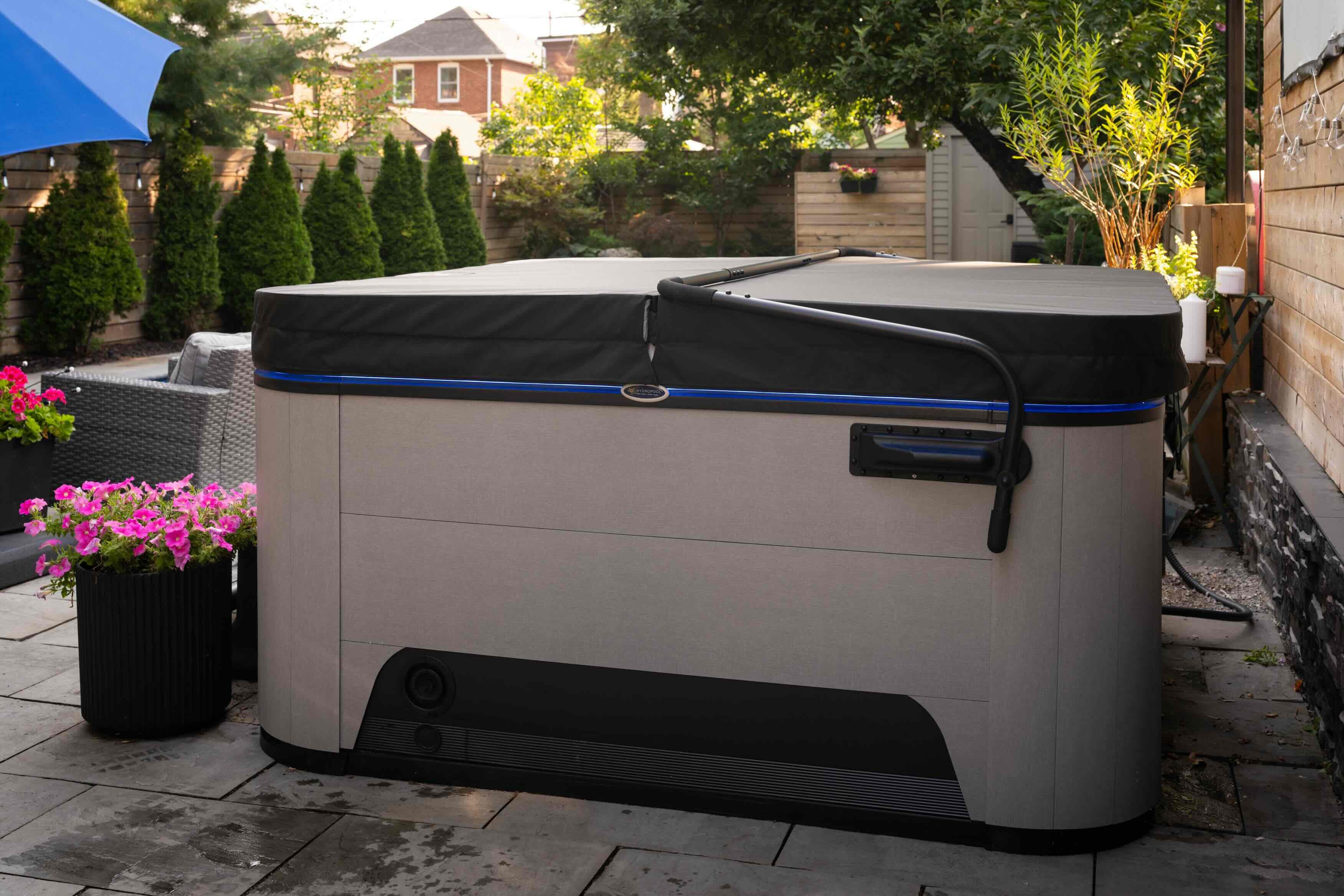 A hot tub cover meticulously maintained and correctly protecting a luxury Hydropool hot tub.
