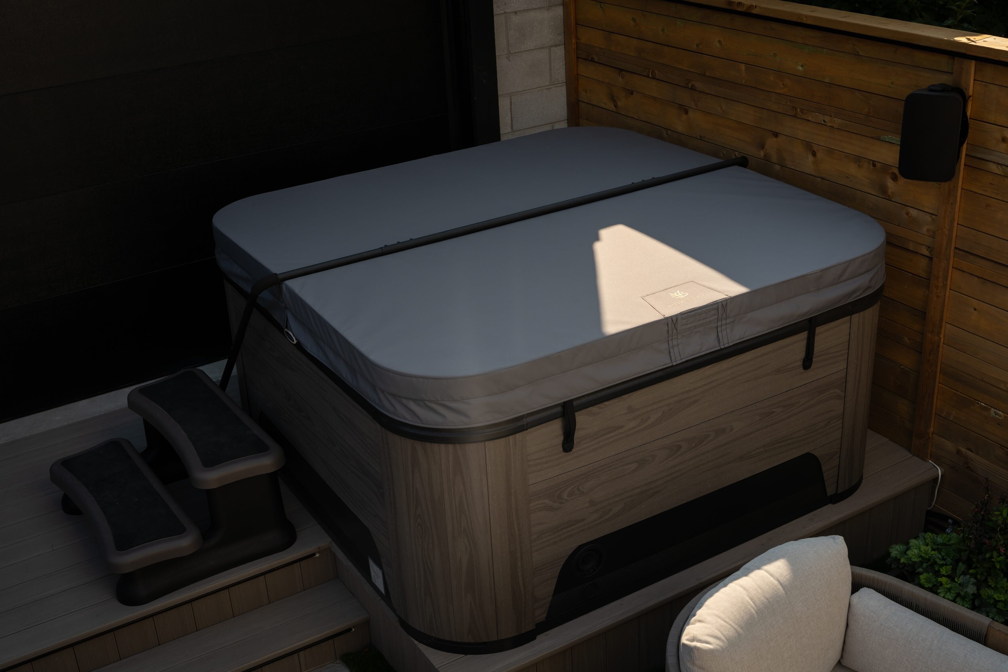 Luxury hot tub safely covered by a pristine hot tub cover, maintained with care tips from Hydropool North West.