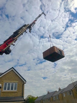 A hot tub being crane-lifted into someone’s back garden ready for installation after purchasing a hot tub from Hydropool North West.