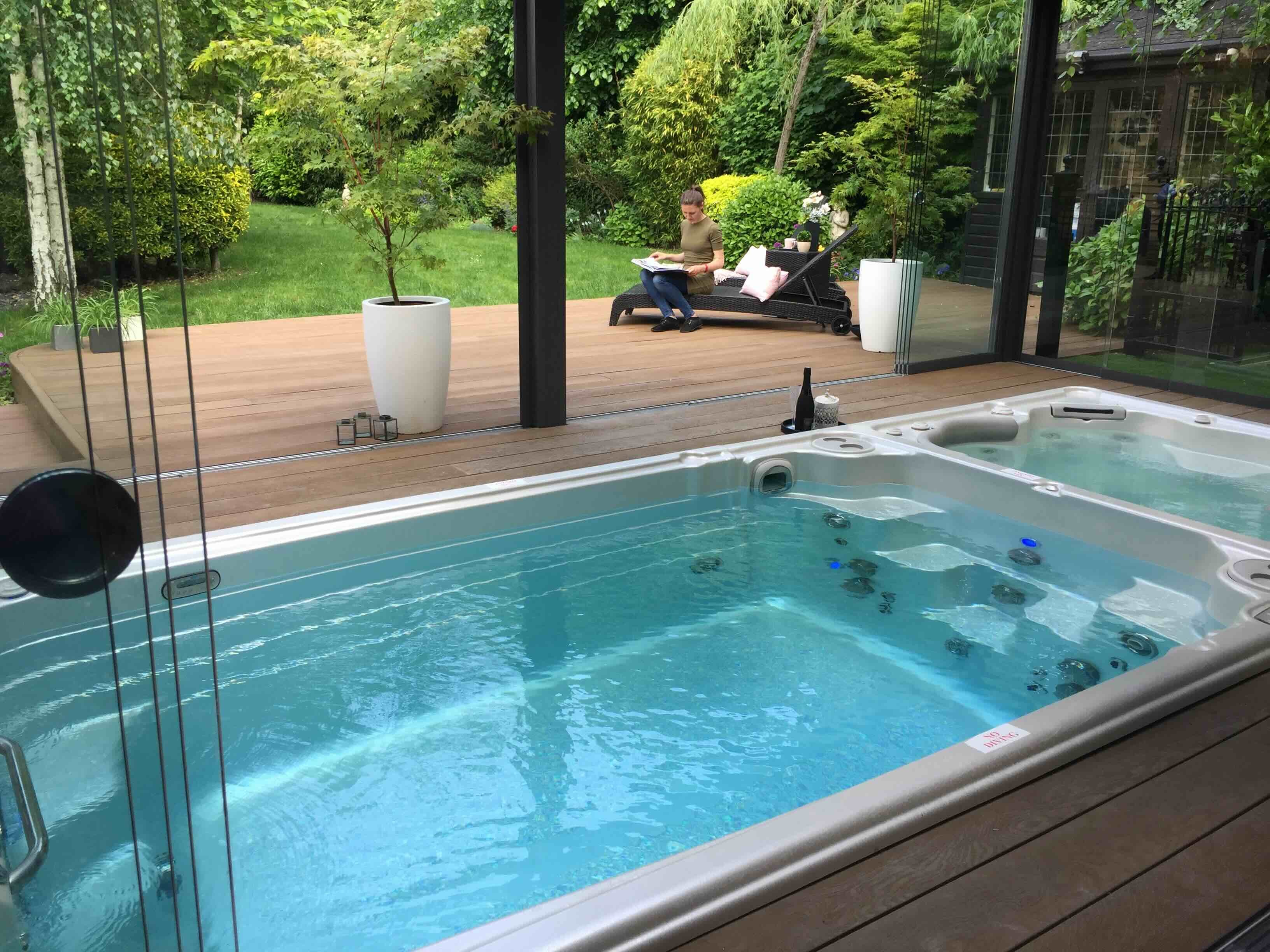 A swim spa with hot tub in an outdoor area at a housing development.