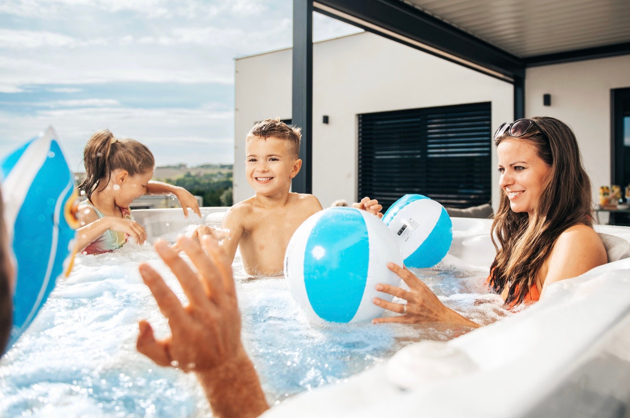 A family plays together in their entry-level hot tub.