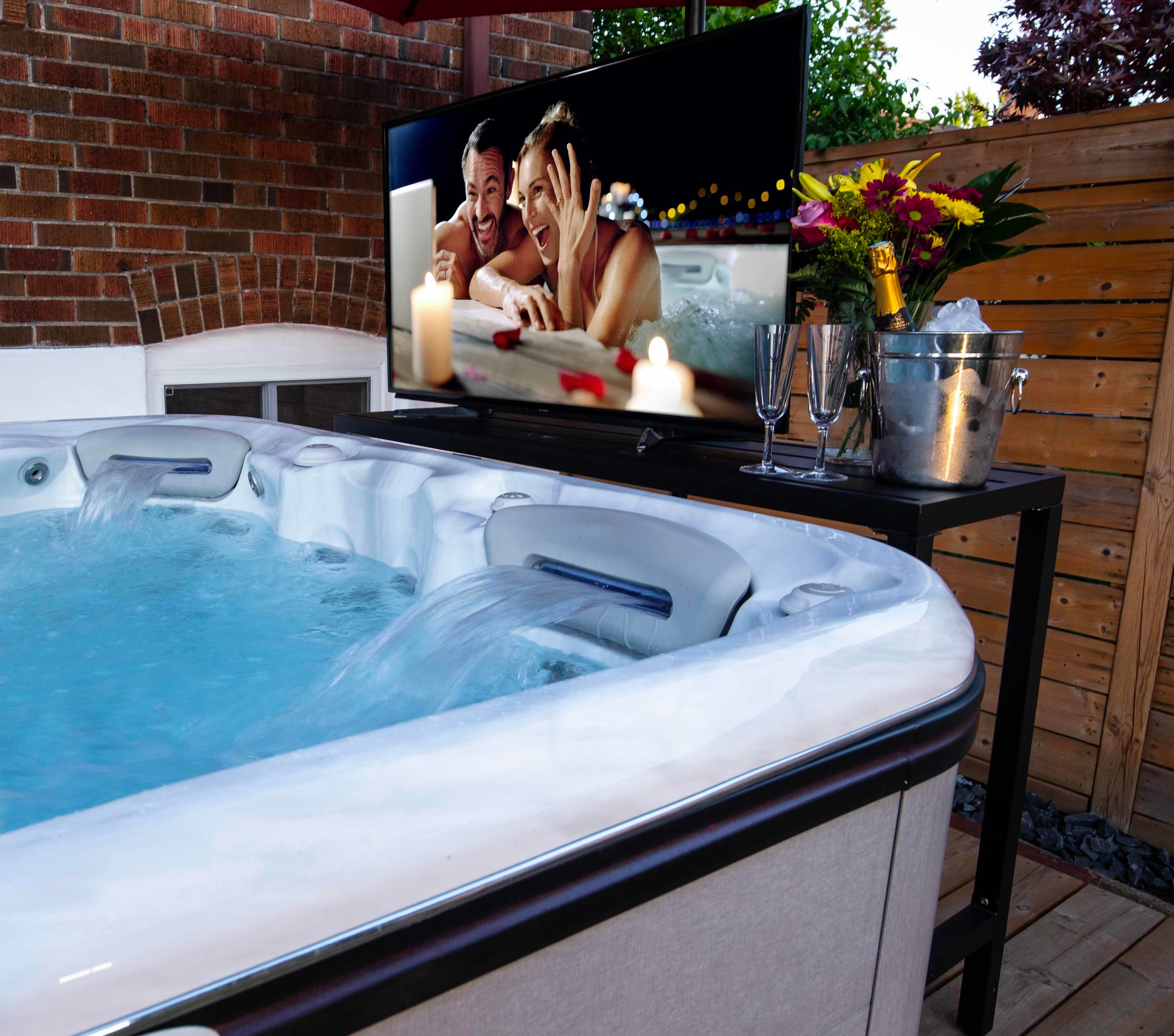 A bucket of champagne sits beside a hot tub ready for the perfect hot tub date.