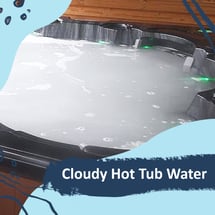 A hot tub completely full of opaque white cloudy water.