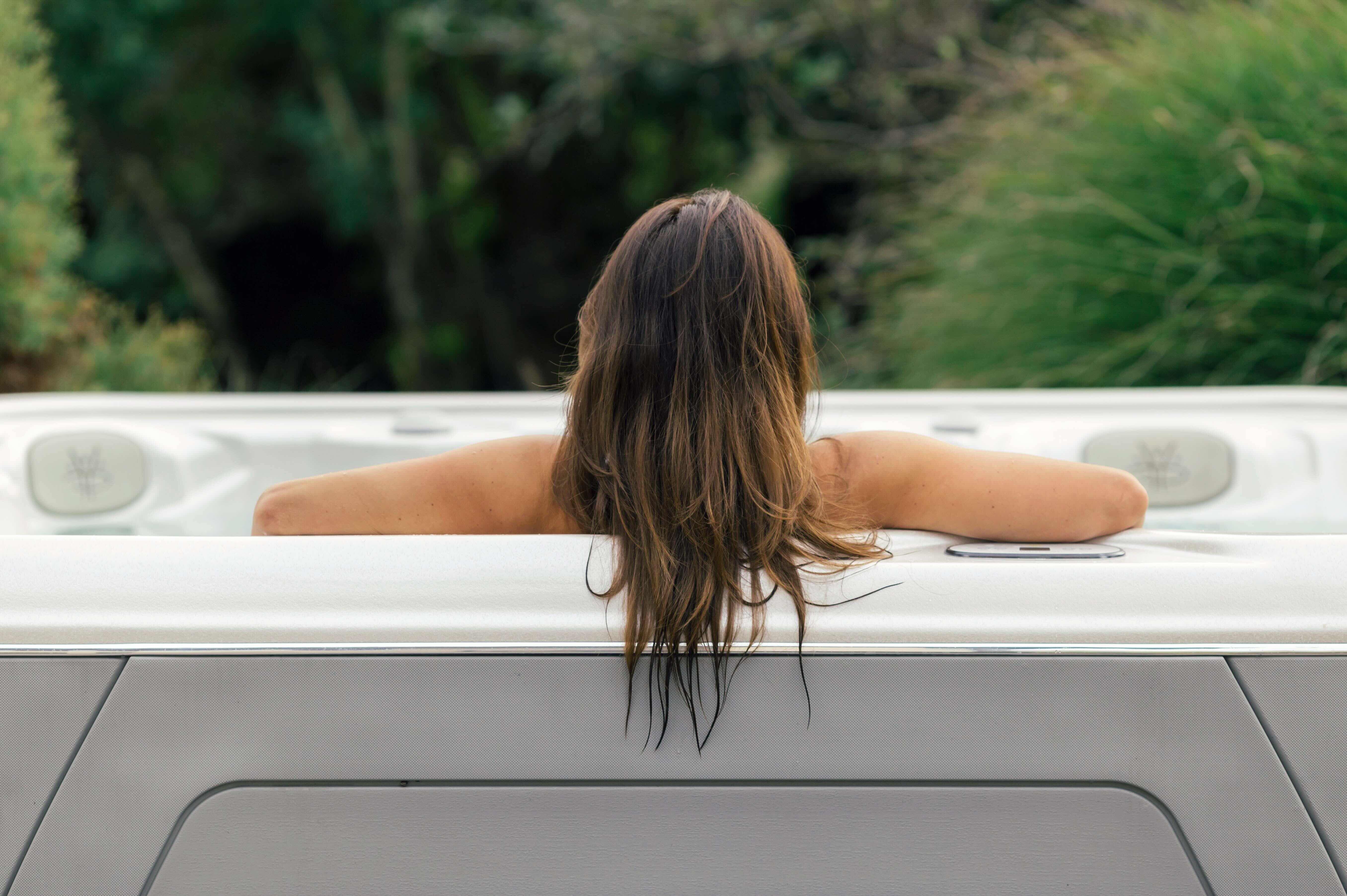 A woman relaxes in her Hydropool hot tub in 2026.