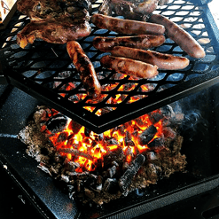 Indoor barbecue grill with sausages cooking. 