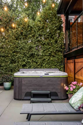 Overhead fairy lights enhance the luxury vibe of a Self-Cleaning hot tub.