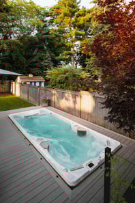 A Hydropool swim spa in-deck in a tight garden space.