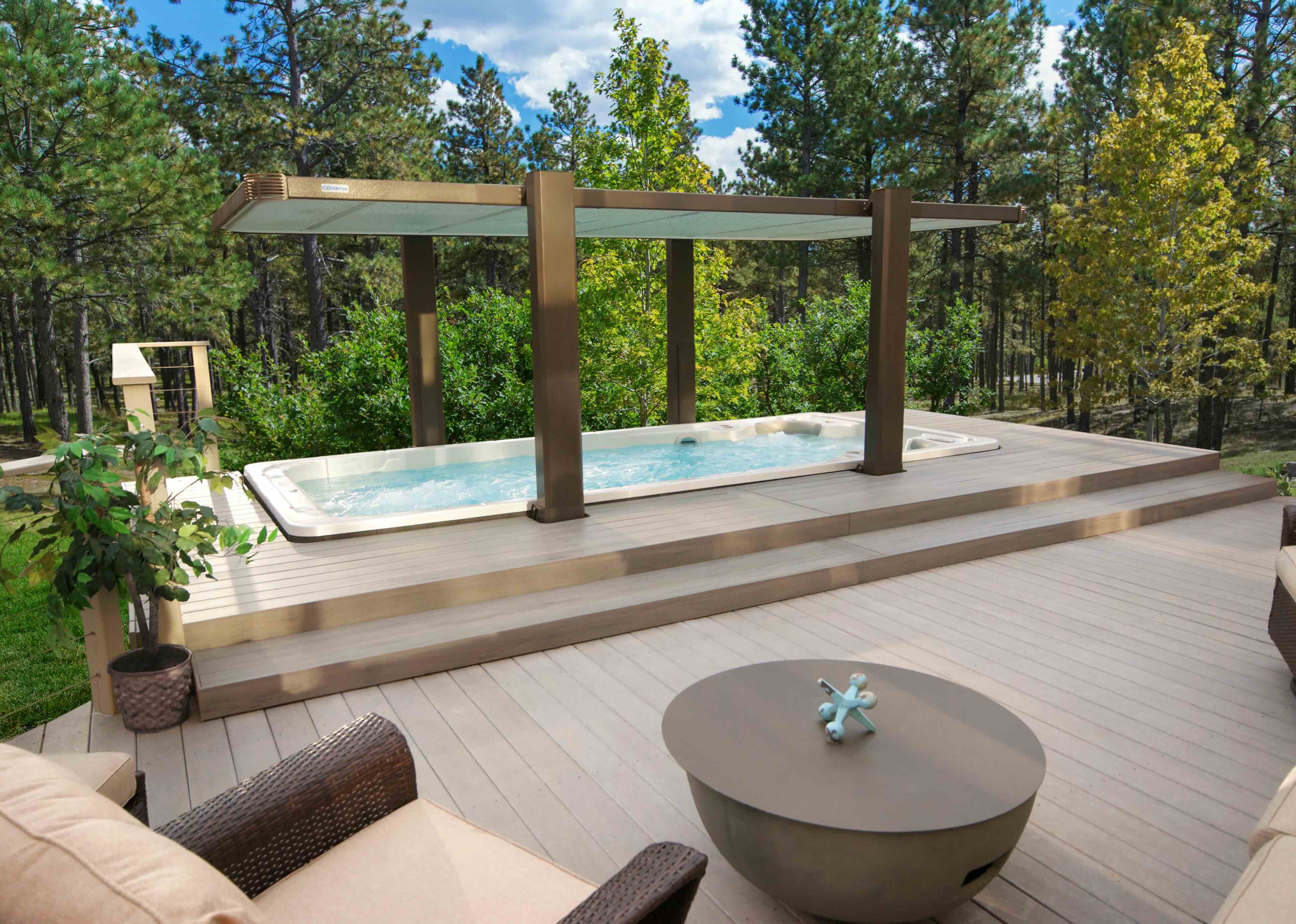 A Hydropool swim spa stylishly installed into a decking with electric covana cover. 