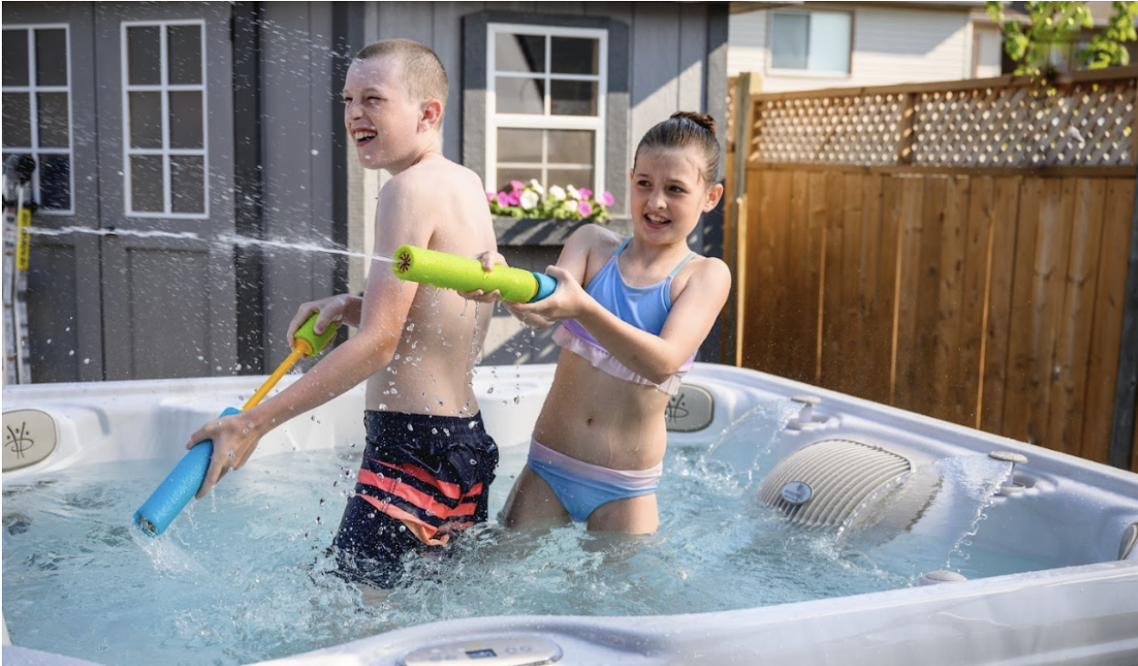 Children having fun in the perfect sized hot tub for their family.  