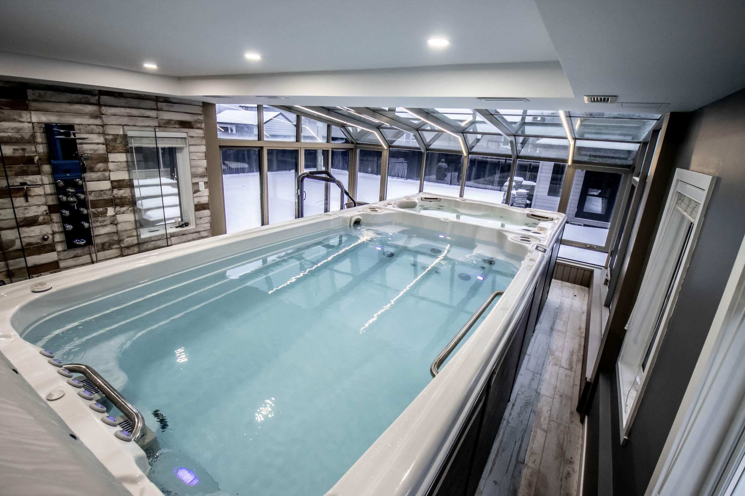 A swim spa integrated into a conservatory to show how it can elevate your property development.  