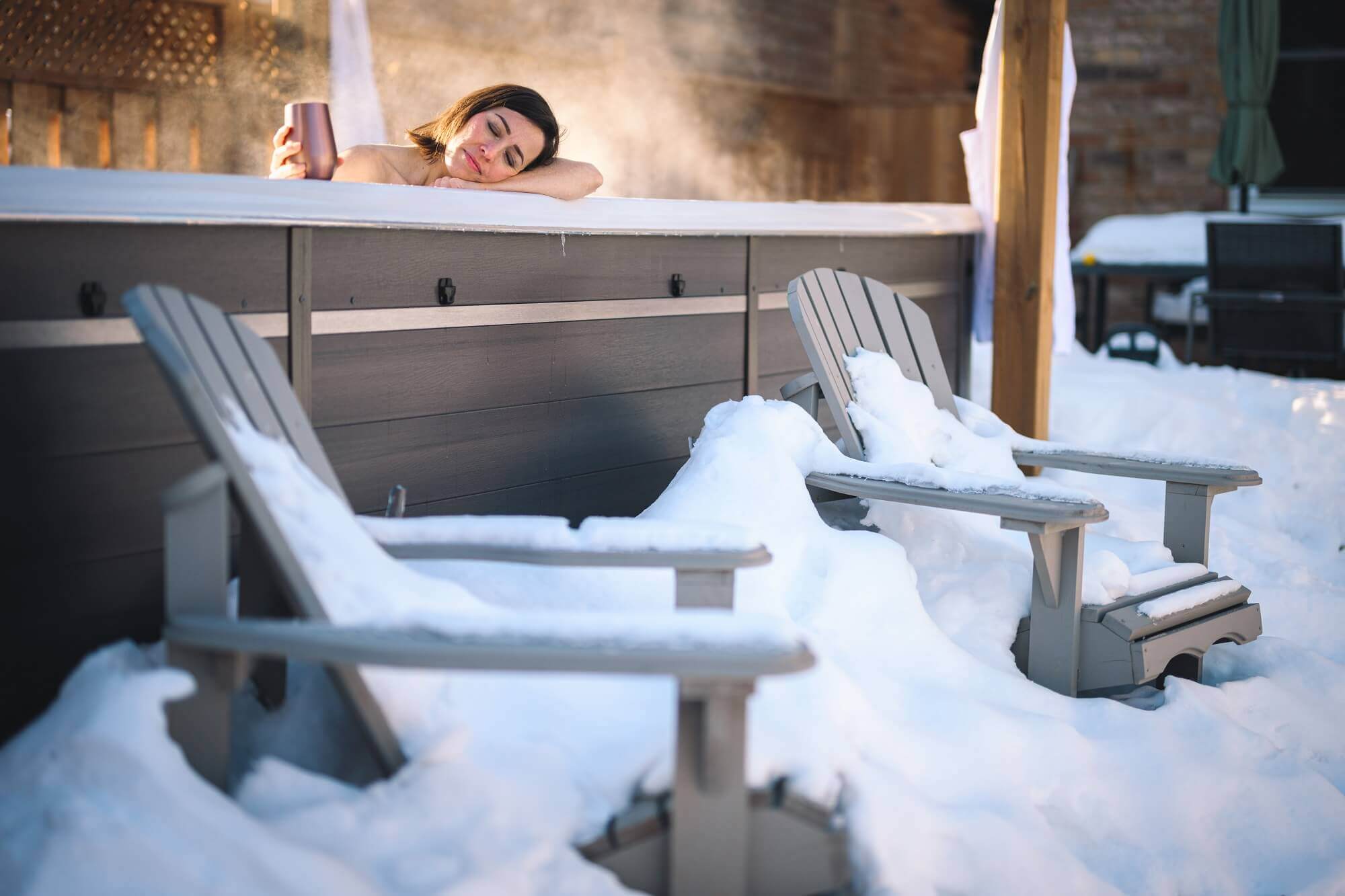 Woman relaxing in a hot tub that has been winterized.