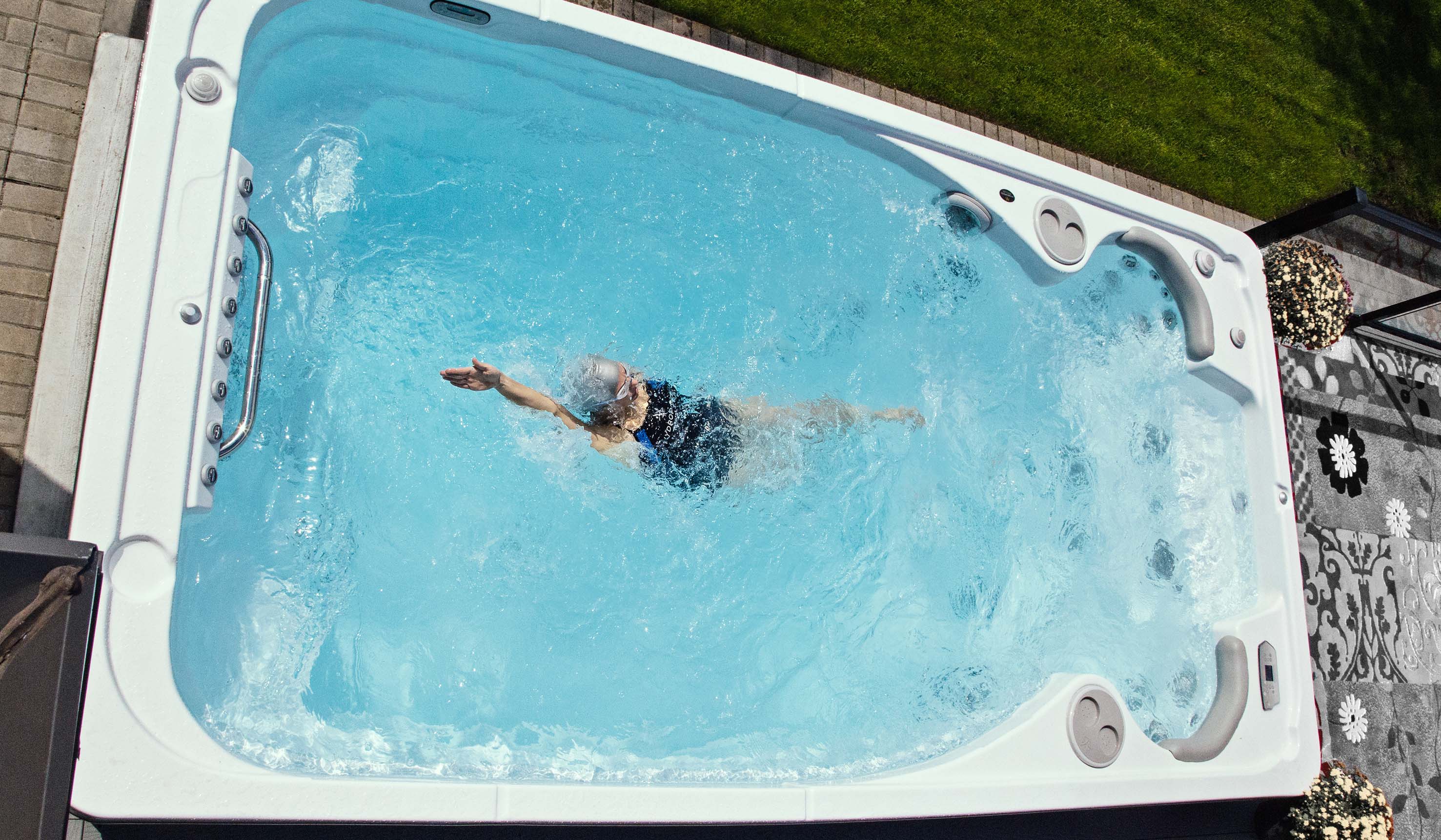 A swimmer doing the backstroke in a swim spa from Hydropool North West. 